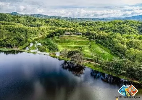 The Best Feng Shui House For Sale, surrounded by reservoir and mountains.